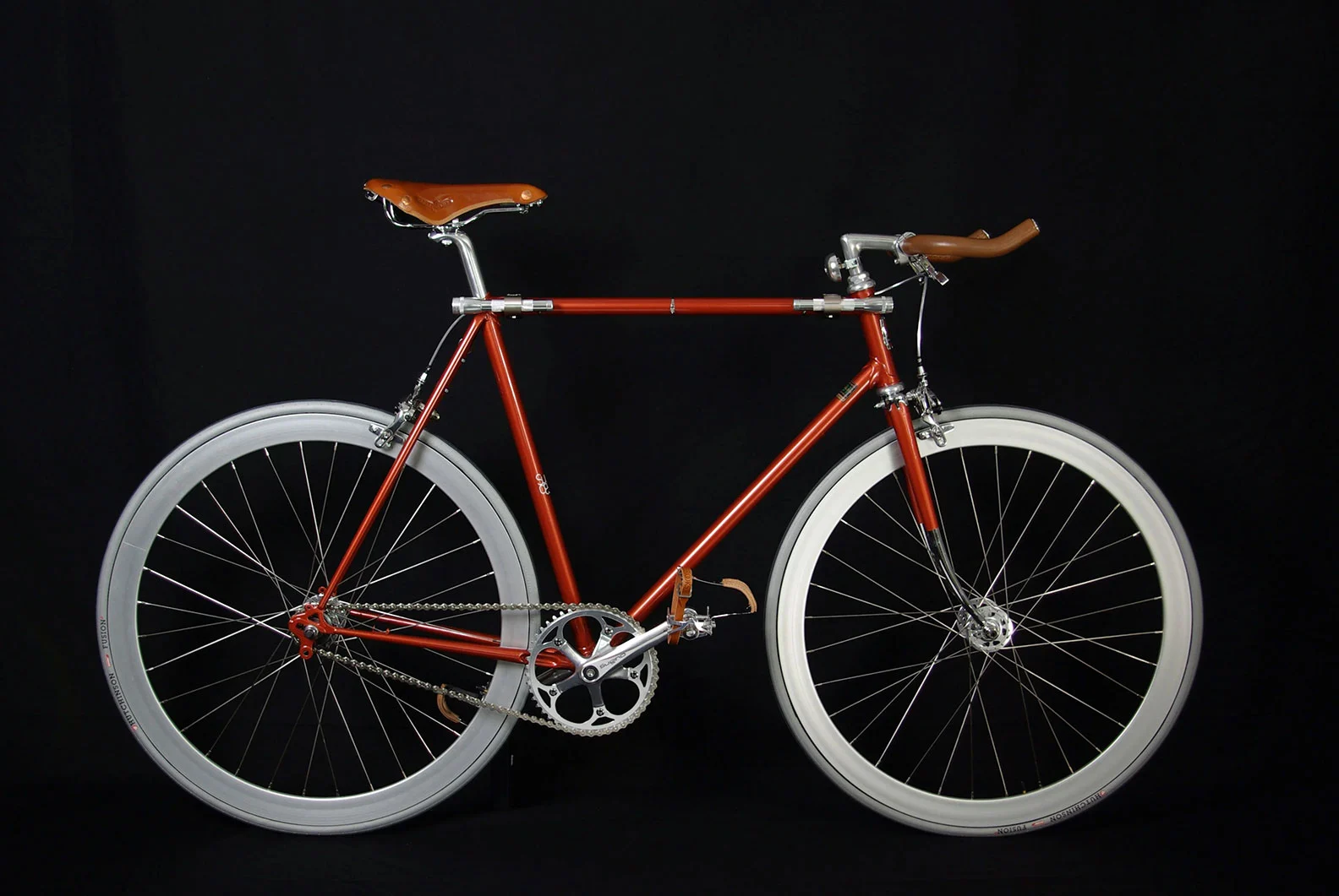 single gear orange Bike with black background, fixed gear bike, product bike