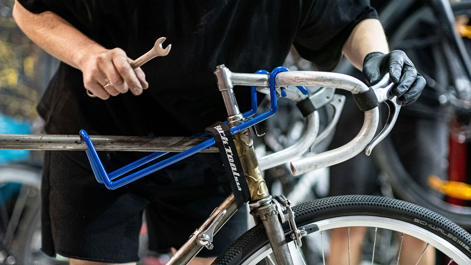 man providing bike services, fixing a bike