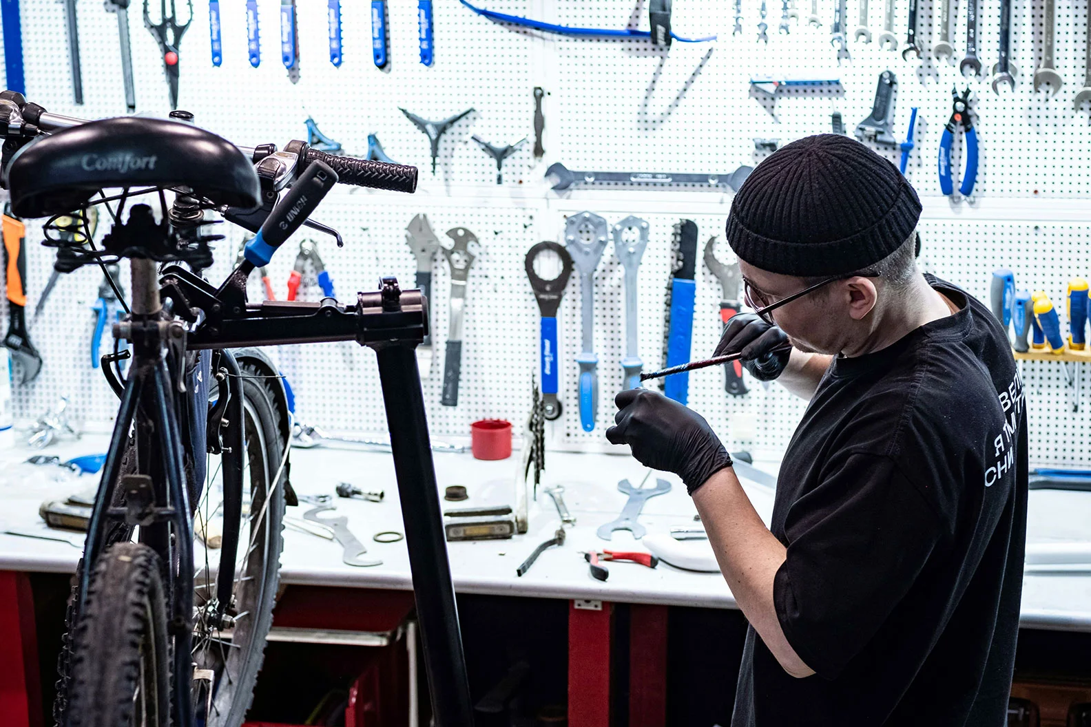 man fixing and servicing a bike