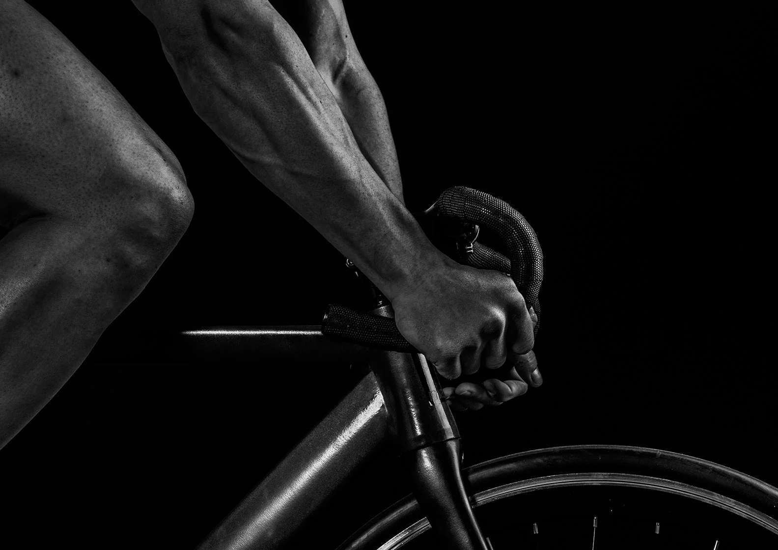 fit man biking on a road bike